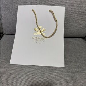 Creed White Bag with Gold Emblem